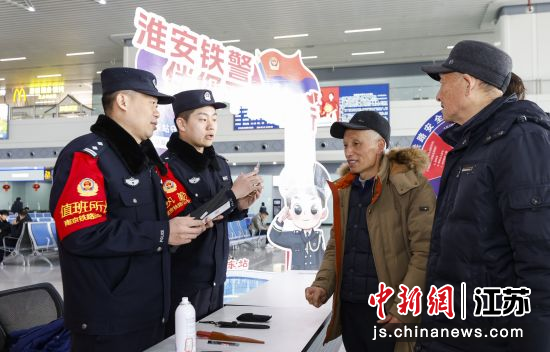 民警向旅客宣传铁路乘车禁止和限制携带物品种类。刘涛 摄